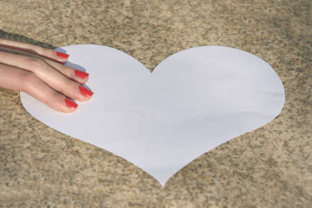 female hand with white heartの写真素材