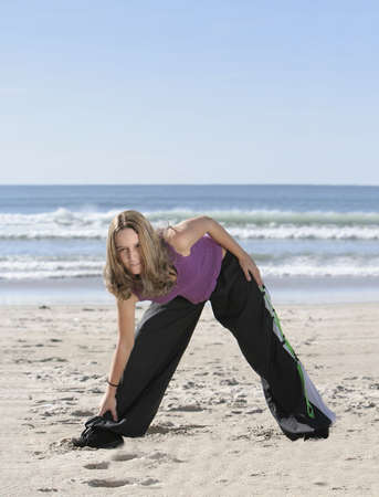 woman stretching at the beach