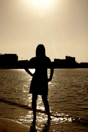 a woman and a view of a city at sunsetの写真素材