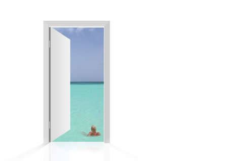 Isolated open door to beach with woman in the seaの写真素材