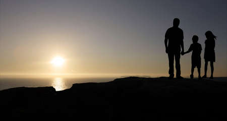 family walking in the mountain  at sunsetの写真素材