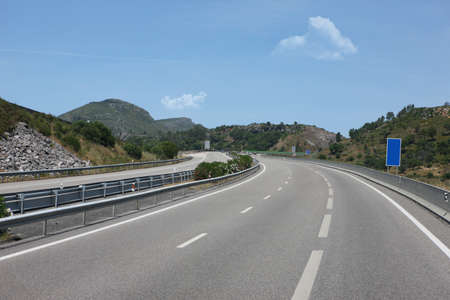 Mountain road curve with blue sky