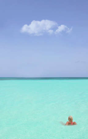 blond woman in the caribbean seaの写真素材