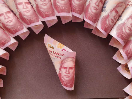 mexican banknotes of fifty pesos on the brown background