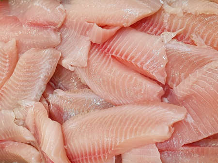 heap of raw fish fillets in a market, background and textureの写真素材