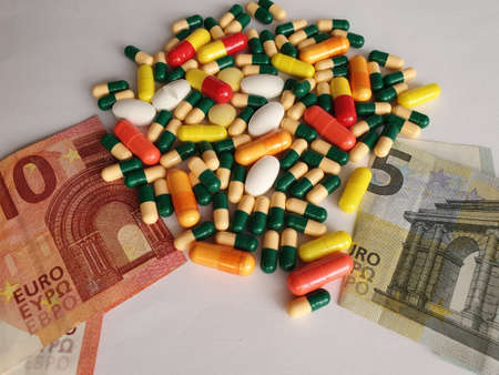 European banknotes of different denominations, capsules and medicine pillsの写真素材