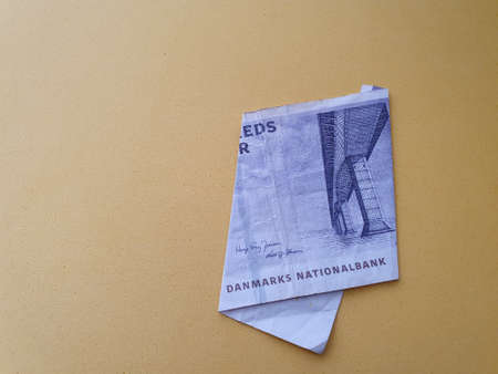 Danish banknote of fifty kroner and yellow background for advertisingの写真素材