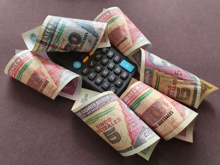 calculator and guatemalan banknotes of different denominations