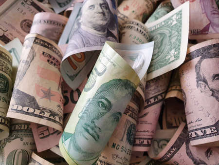 approach to singaporean banknote of five dollars and american dollar moneyの写真素材