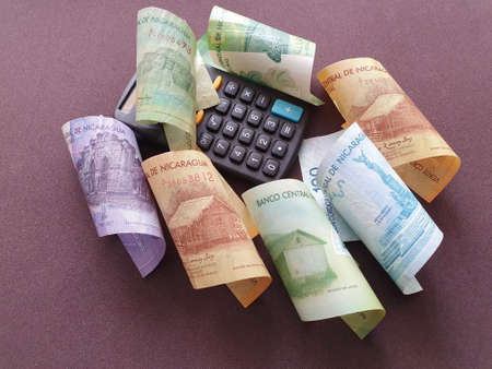 black calculator and nicaraguan banknotes of different denominationsの写真素材