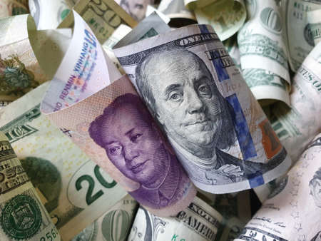 approach to Chinese banknote of five yuan and american dollar money