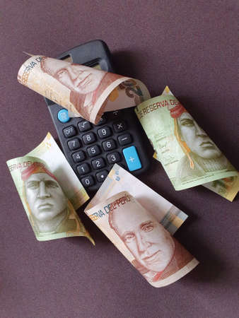 black calculator and peruvian banknotes of different denominationsの写真素材