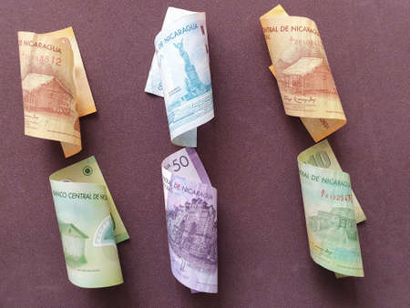 nicaraguan banknotes of different denominations and brown backgroundの写真素材