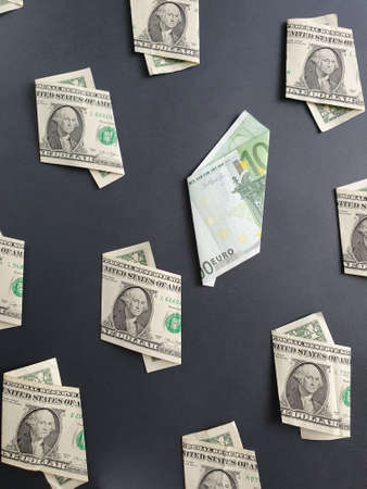 american one dollar bills and european banknote of 100 euro on the black background