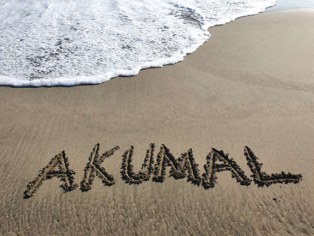 Akumal text handwritten in beach sand, background and textureの写真素材