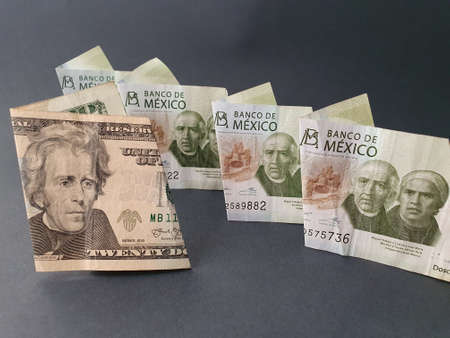 twenty american dollar banknote and mexican 200 peso bills
