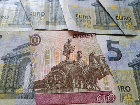 russian banknote of 100 rubles and european bills of five euro