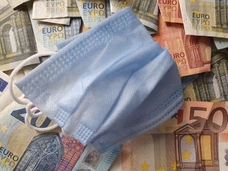 blue disposable mask and european banknotes of different denominationsの写真素材