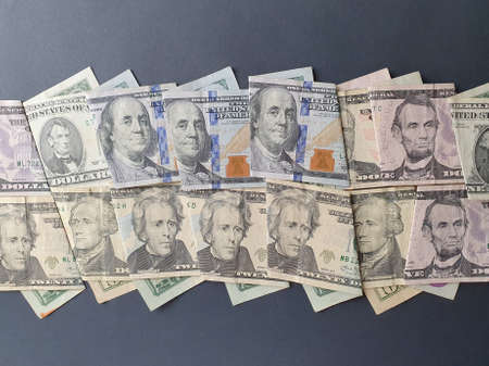 american dollar banknotes of different denominations and black background