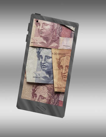 illustration with the icon of a smartphone and the image of brazilian moneyの写真素材