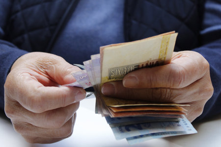 approach to hands of a woman counting brazilian banknotesの写真素材
