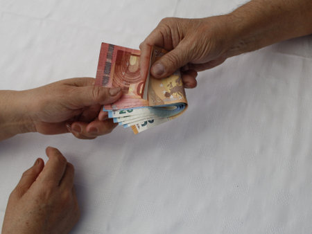 hands paying and receiving european banknotes of different denominations