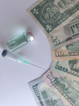 american dollar banknotes, syringe and bottle with medicineの写真素材