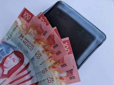 mexican banknotes of 100 pesos and black leather walletの写真素材