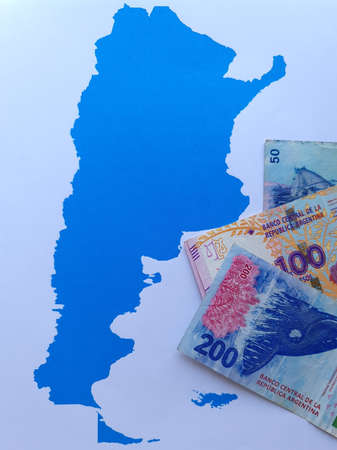 argentine banknotes and background with Argentina map silhouette