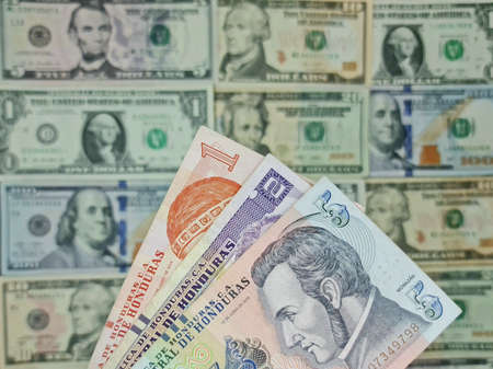 approach to honduran banknotes and background with american dollar bills
