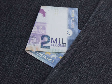 Costa Rican banknote of 2000 colones between blue denim fabricの写真素材