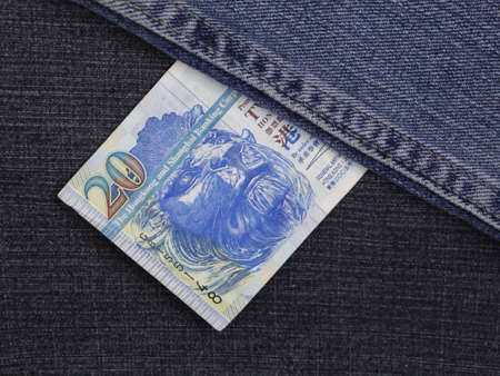 Hong Kong banknote of twenty dollars between blue denim fabricの写真素材