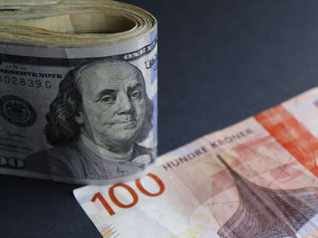 american bill of 100 dollars and norwegian banknote of 100 kroner