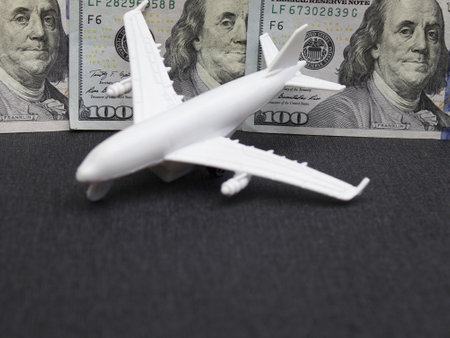 american dollars banknotes and figure of a white planeの写真素材