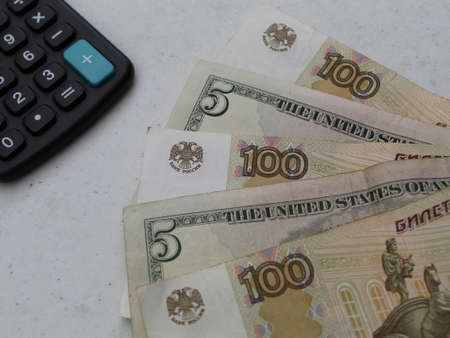 russian banknote of 200 rubles, american five dollars bills and calculator