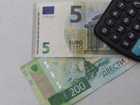 russian banknote of 200 rubles, european bill of five euro and calculatorの写真素材