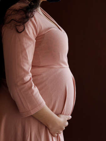 profile of a woman with a dress during her pregnancy stageの写真素材