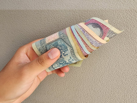 hand of a man holding and paying with guatemalan banknotes