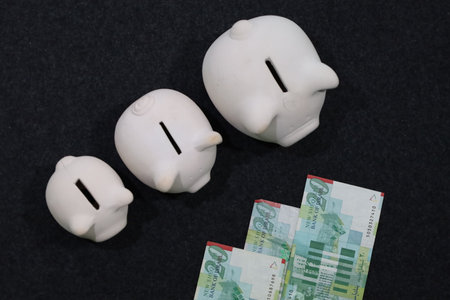 israeli banknotes and piggy banks of different sizes
