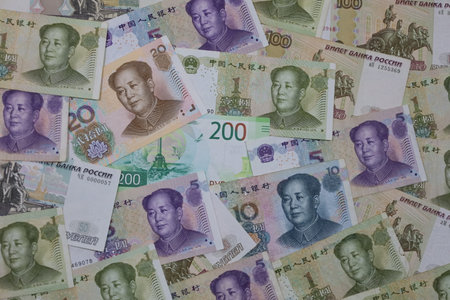 stacked chinese banknotes and russian bills