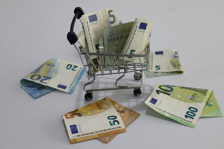 shopping cart and European banknotes of different denominationsの写真素材
