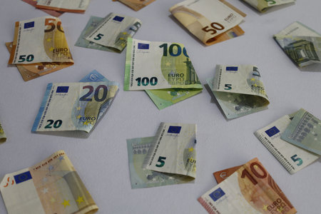 European banknotes of different denominations folded on the tableの写真素材