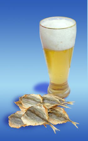 A glass of beer and dried fish are shown in the picture.         の写真素材