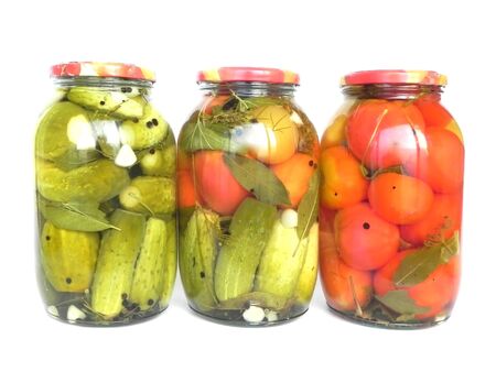 Banks with canned tomatoes and cucumbers are shown in the picture.の写真素材
