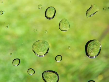 Drops of water on glass and blurred natural background                                の写真素材