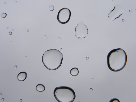 Drops of water on glass and blurred gray background                                の写真素材
