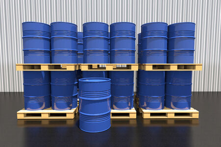 Metal barrels of fuel on a wooden pallet in the industrial warehouse.の写真素材