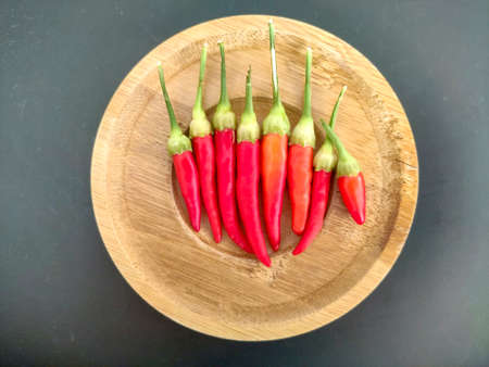 red hot chili peppers on wooden plateの写真素材