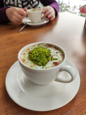 A delicious winter drink; sahlep with ground pistachios on topの写真素材