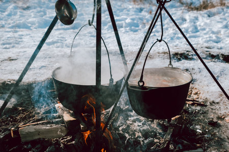 The food is cooked in two pots over a fireの写真素材
